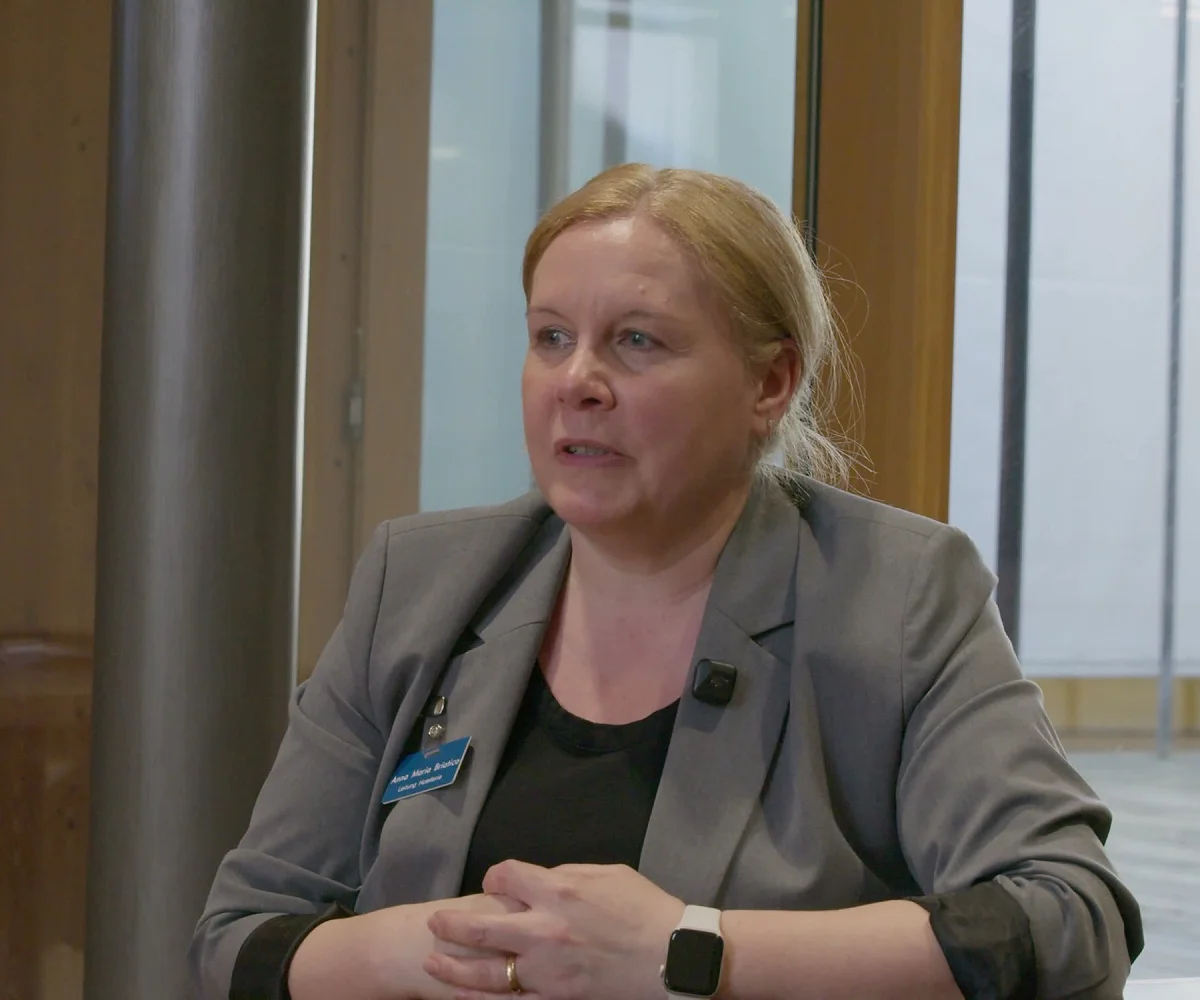 Mitarbeiterin von Bardusch im Interview vor einer Glasfassade